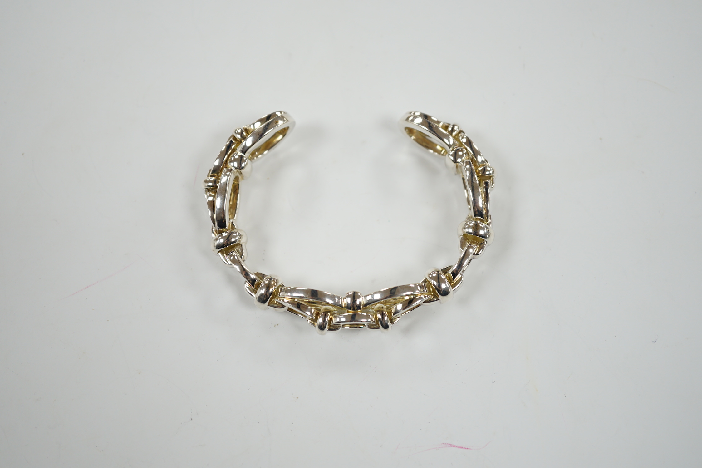 A modern Links of London silver oval link open work bangle, 60 grams, in Links of London box.